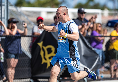 A Special Olympics athlete runs to the finish line.